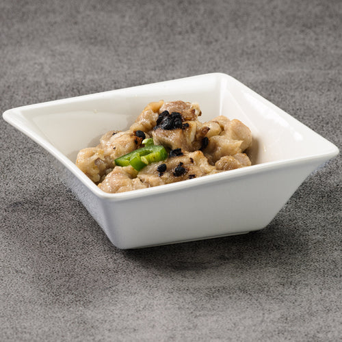 White square bowl with food on a gray surface