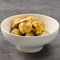 White bowl filled with wontons on a gray background