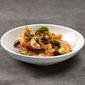 White bowl with fried shrimp on a gray background