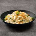 Black bowl of rice with scallops on a gray background
