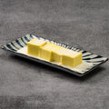 Mango pudding on a decorative rectangular plate with a zebra pattern on a gray background