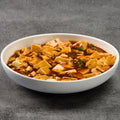 Bowl of mapo tofu dish on a gray background