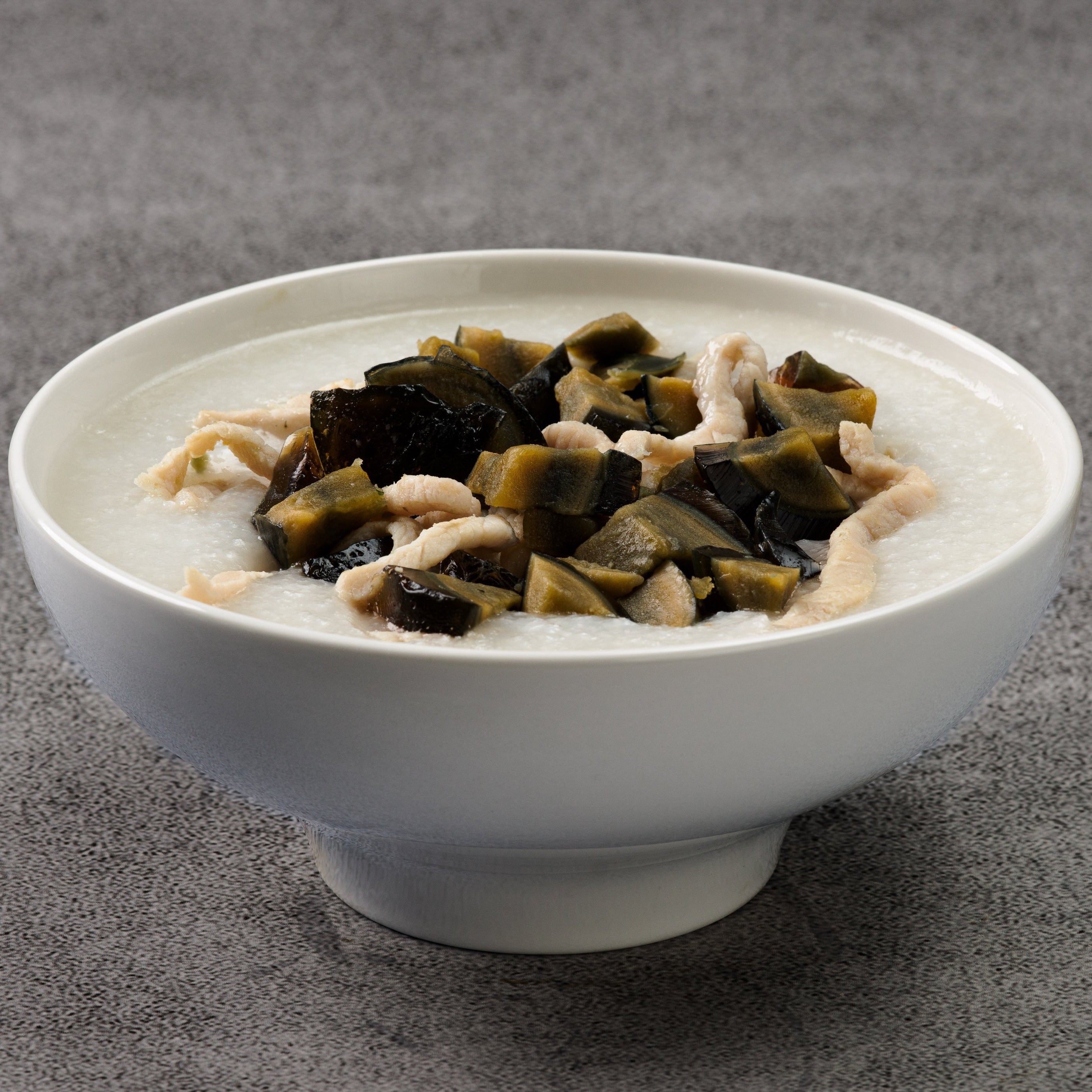 White bowl with a mixture of ingredients on a gray background