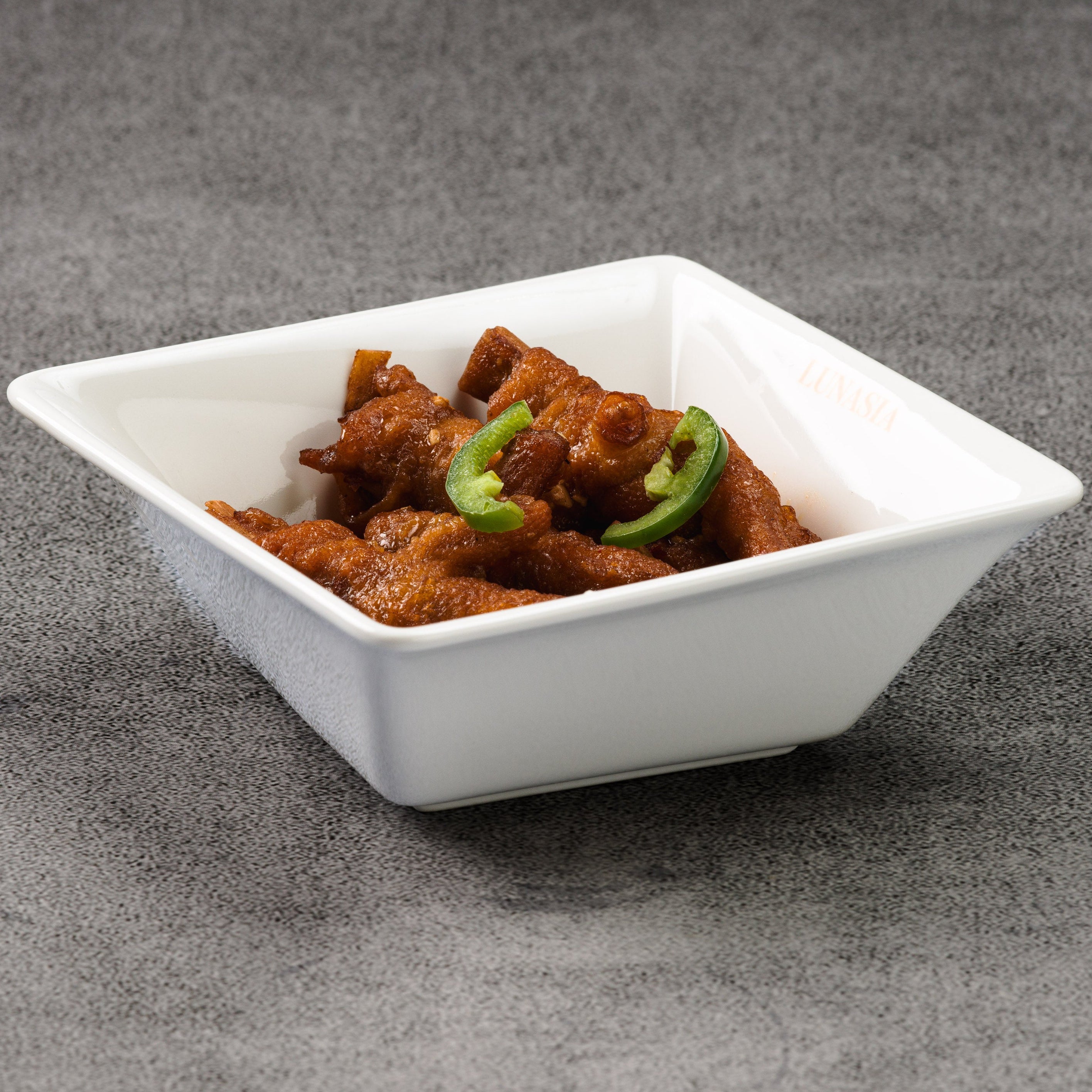 White square bowl with chicken feet on a gray background